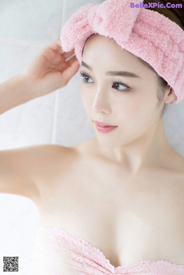 A woman wearing a pink towel on her head.