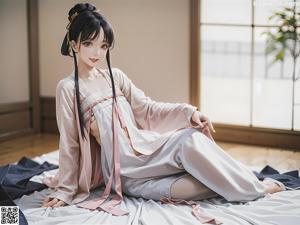 A woman in a white kimono is posing for a picture.