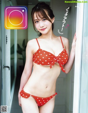 A woman in a blue and white bikini posing for a picture.