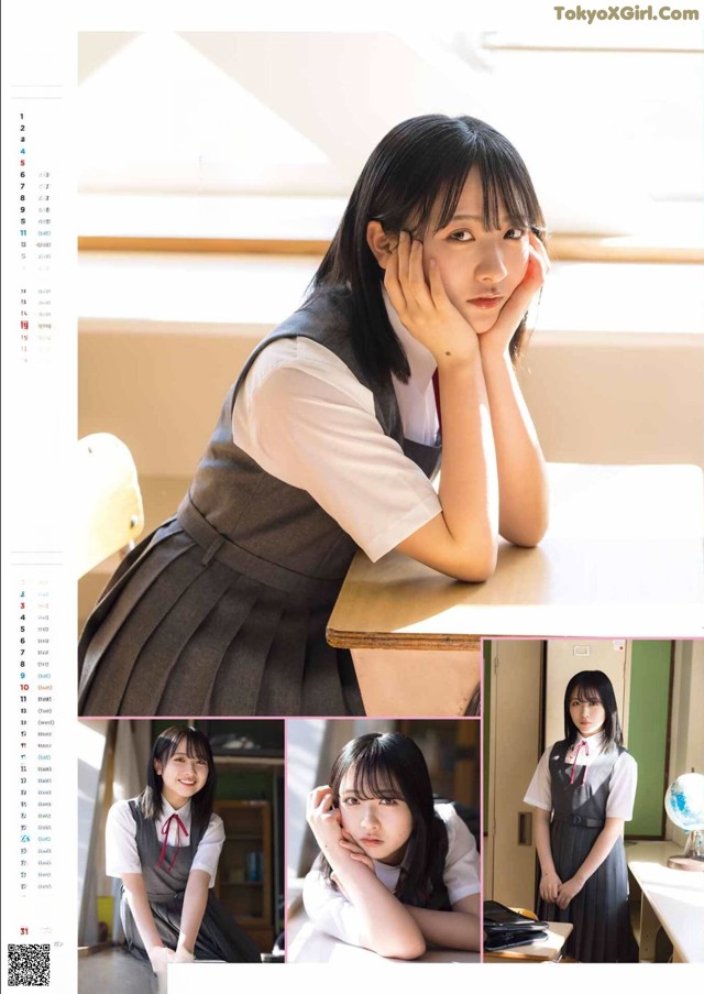 A girl in a school uniform sitting at a desk.