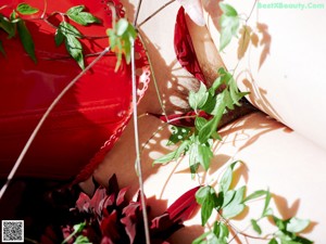 A close up of a red umbrella with leaves on it.