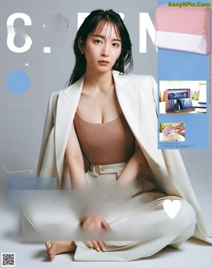 A magazine with a picture of a woman in a white sweater.