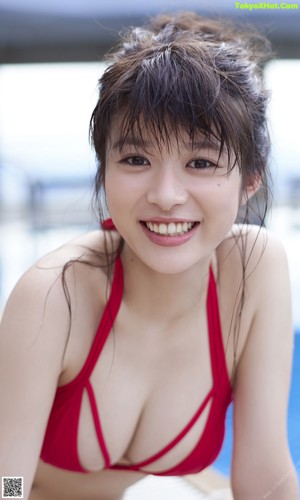 A woman in a red bikini in a swimming pool.